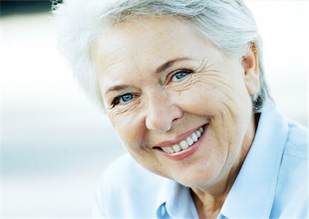 simsearch:693-06019332,k - Mature woman smiling, close-up, portrait Stock Photo - Premium Royalty-Free, Code: 695-05773708