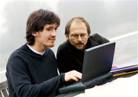 fog (steamed up) - Two men working on laptop computer outdoors Stock Photo - Premium Royalty-Free, Code: 695-05773834