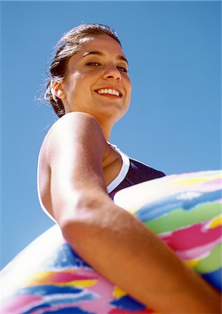 Woman holding inner tube, low angle view Stock Photo - Premium Royalty-Free, Code: 695-05773968