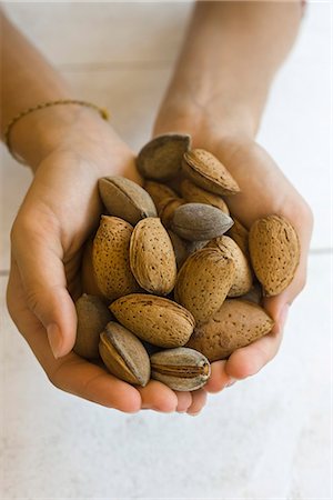 person cupping hands - Hands holding almonds Stock Photo - Premium Royalty-Free, Code: 695-05780051