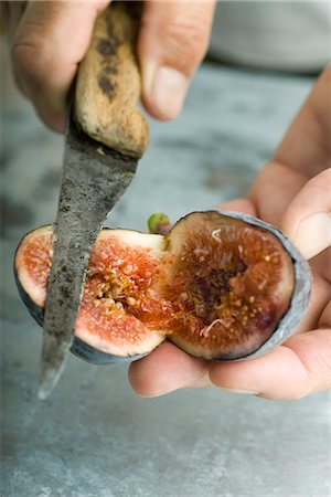 Cutting a ripe fig Stock Photo - Premium Royalty-Free, Code: 695-05780125