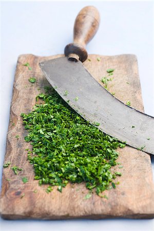 sativum coriander - Freshly chopped herbs on cutting board Stock Photo - Premium Royalty-Free, Code: 695-05780140