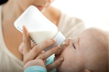 Baby drinking milk from bottle Fotografie stock - Premium Royalty-Free, Codice: 695-05780170