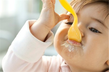 food and baby - Infant eating with spoon Stock Photo - Premium Royalty-Free, Code: 695-05780173