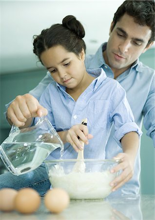 Father and daughter making batter together Stock Photo - Premium Royalty-Free, Code: 695-03374332