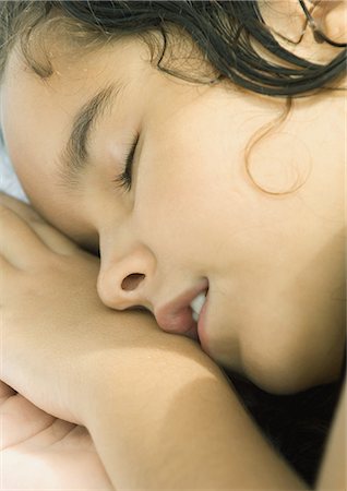 Girl resting head on hands, close-up Stock Photo - Premium Royalty-Free, Code: 695-03374355