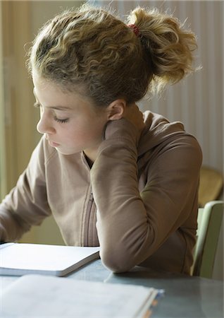 disciplining child - Preteen girl doing homework Stock Photo - Premium Royalty-Free, Code: 695-03374374