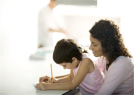 Mother helping child with homework Stock Photo - Premium Royalty-Free, Code: 695-03374371