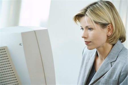 Businesswoman using desktop computer Stock Photo - Premium Royalty-Free, Code: 695-03374479