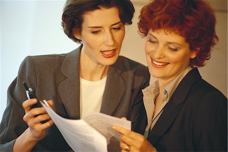 simsearch:632-01155400,k - Two business women, looking at document Stock Photo - Premium Royalty-Free, Code: 695-03374472