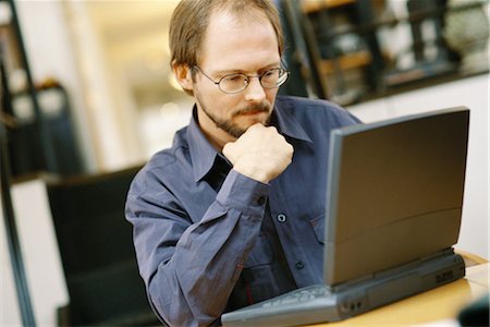 Man using laptop Stock Photo - Premium Royalty-Free, Code: 695-03374577