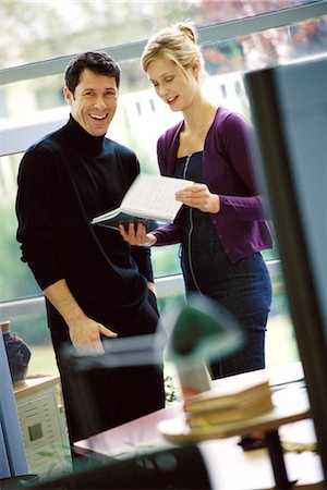 simsearch:695-03374588,k - Two business colleagues looking at agenda, laughing Stock Photo - Premium Royalty-Free, Code: 695-03374595