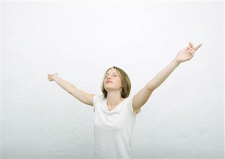 simsearch:695-03375411,k - Teenage girl standing with arms out and eyes closed, portrait Stock Photo - Premium Royalty-Free, Code: 695-03374719