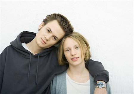 Young couple leaning against wall, looking at camera, portrait Stock Photo - Premium Royalty-Free, Code: 695-03374768