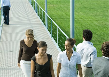 Young professionals walking and standing on walkway Stock Photo - Premium Royalty-Free, Code: 695-03374856