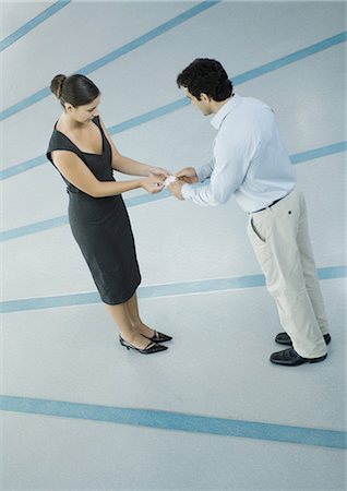 Business associates exchanging business cards Stock Photo - Premium Royalty-Free, Code: 695-03374851