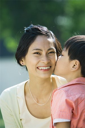 simsearch:695-03375963,k - Boy kissing mother on cheek, woman smiling at camera, close-up Stock Photo - Premium Royalty-Free, Code: 695-03374875