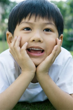 Boy smiling, head and shoulders, portrait Stock Photo - Premium Royalty-Free, Code: 695-03374902
