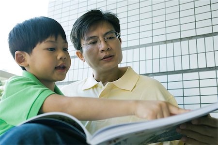 simsearch:696-03401226,k - Father and son looking at book together Stock Photo - Premium Royalty-Free, Code: 695-03374912