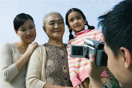 simsearch:695-03377503,k - Man filming family with video camera Stock Photo - Premium Royalty-Free, Code: 695-03374950