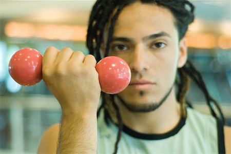 simsearch:695-03375202,k - Young man holding up dumbbell Stock Photo - Premium Royalty-Free, Code: 695-03375111