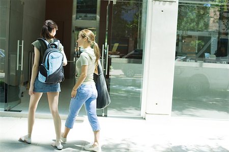 friends sidewalk walk - Two young women walking toward doorway together Stock Photo - Premium Royalty-Free, Code: 695-03375256