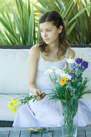 sad woman sitting alone on couch - Young woman making fresh flower arrangement Stock Photo - Premium Royalty-Free, Code: 695-03375375