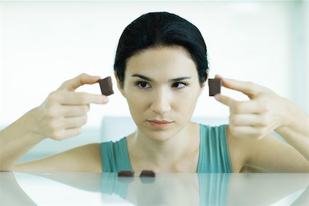 simsearch:695-05779160,k - Woman holding up pieces of chocolate Stock Photo - Premium Royalty-Free, Code: 695-03375536