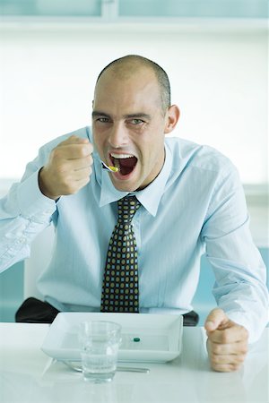 empty plate of food - Man using fork to eat vitamins from plate Stock Photo - Premium Royalty-Free, Code: 695-03375544