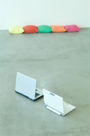 floor cushion - Two laptops on floor, cushions in background Stock Photo - Premium Royalty-Free, Code: 695-03375667