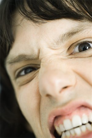 face close up young man looking sideways - Teen boy making angry face, extreme close-up Stock Photo - Premium Royalty-Free, Code: 695-03375786