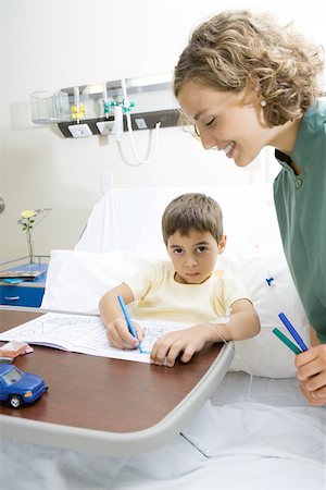 Boy lying in hospital bed, coloring Stock Photo - Premium Royalty-Free, Code: 695-03375865