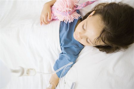 person in hospital bed overhead - Girl lying in hospital bed Stock Photo - Premium Royalty-Free, Code: 695-03375870