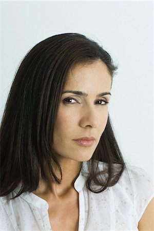 distrust - Woman giving sideways glance to camera, portrait Stock Photo - Premium Royalty-Free, Code: 695-03375982