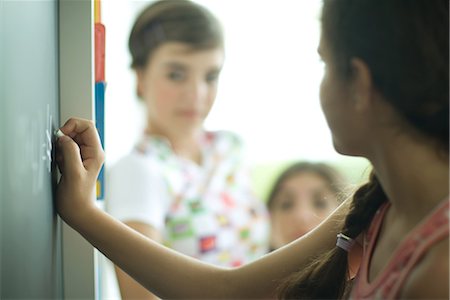 Young female friends writing on chalkboard Stock Photo - Premium Royalty-Free, Code: 695-03376020