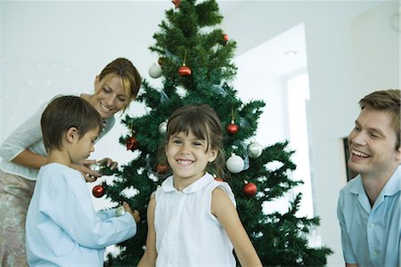 Family decorating Christmas tree Stock Photo - Premium Royalty-Free, Code: 695-03376097