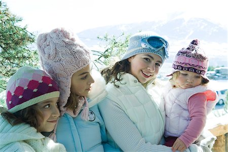 simsearch:695-03389357,k - Three teen or preteen girls with toddler in mountains, all wearing winter coats and hats, portrait Stock Photo - Premium Royalty-Free, Code: 695-03376173