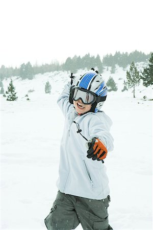 Boy throwing snowball, dressed in ski clothing, three quarter length Stock Photo - Premium Royalty-Free, Code: 695-03376313