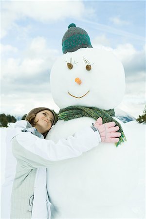 snow cone - Girl embracing snowman, smiling, portrait Stock Photo - Premium Royalty-Free, Code: 695-03376324