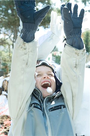 simsearch:696-03401767,k - Boy with arms raised in snow, smiling, eyes closed, head and shoulders Stock Photo - Premium Royalty-Free, Code: 695-03376345