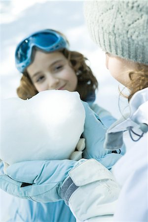 simsearch:695-03389357,k - Teenage girl holding heart made of snow, sister smiling in background Stock Photo - Premium Royalty-Free, Code: 695-03376347