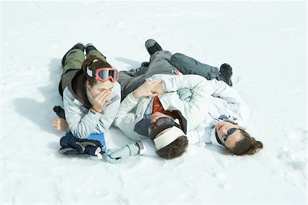 simsearch:632-01613222,k - Three young friends reclining in snow, one holding head Stock Photo - Premium Royalty-Free, Code: 695-03376342