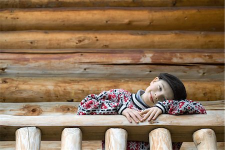 slumped over - Boy standing on deck of wood cabin, leaning on rail Stock Photo - Premium Royalty-Free, Code: 695-03376361