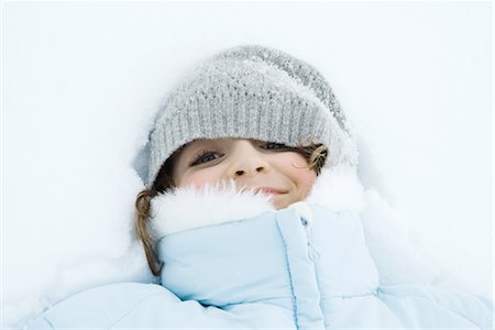 furry preteen - Girl lying in snow, close-up Stock Photo - Premium Royalty-Free, Code: 695-03376372