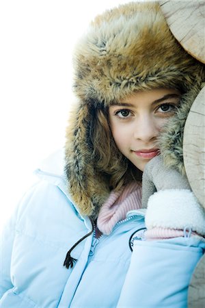 furry preteen - Preteen girl wearing fur hat and winter jacket, smiling at camera, portrait Stock Photo - Premium Royalty-Free, Code: 695-03376419