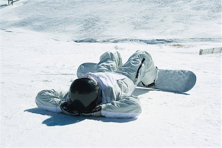 simsearch:696-03401844,k - Young snowboarder lying on back in snow, hands behind head, full length Stock Photo - Premium Royalty-Free, Code: 695-03376446
