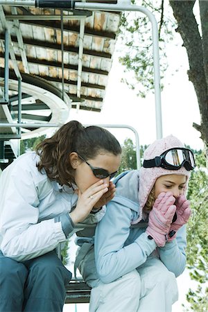 simsearch:695-03389357,k - Teenage girls sitting on chair lift together, leaning over, shouting Stock Photo - Premium Royalty-Free, Code: 695-03376495