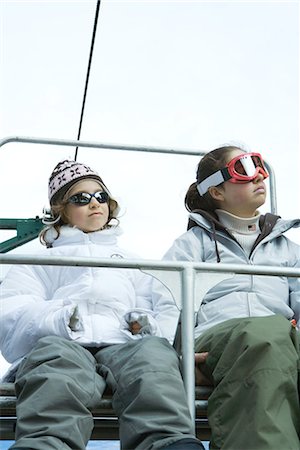 simsearch:695-03373539,k - Two young friends sitting on chair lift, side by side, looking away Stock Photo - Premium Royalty-Free, Code: 695-03376492