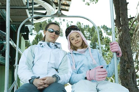 simsearch:695-03373539,k - Two teenage girls sitting together on chair lift, smiling at camera Stock Photo - Premium Royalty-Free, Code: 695-03376493