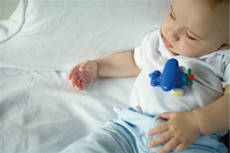 fat person sleeping - Sleeping baby with toy on stomach, high angle view Stock Photo - Premium Royalty-Free, Code: 695-03376588